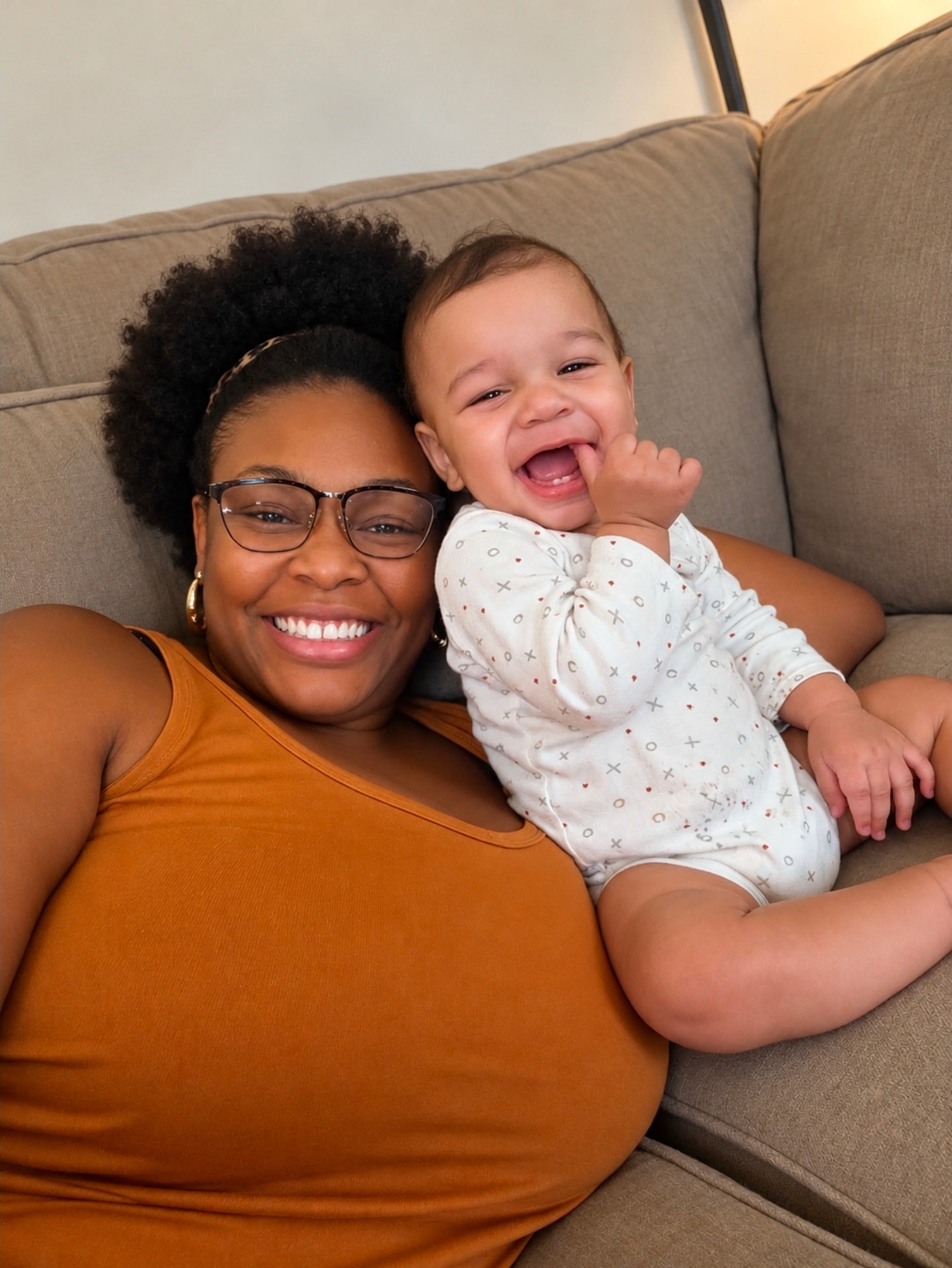 A giggling baby snuggled up on Nanny Kia's shoulder