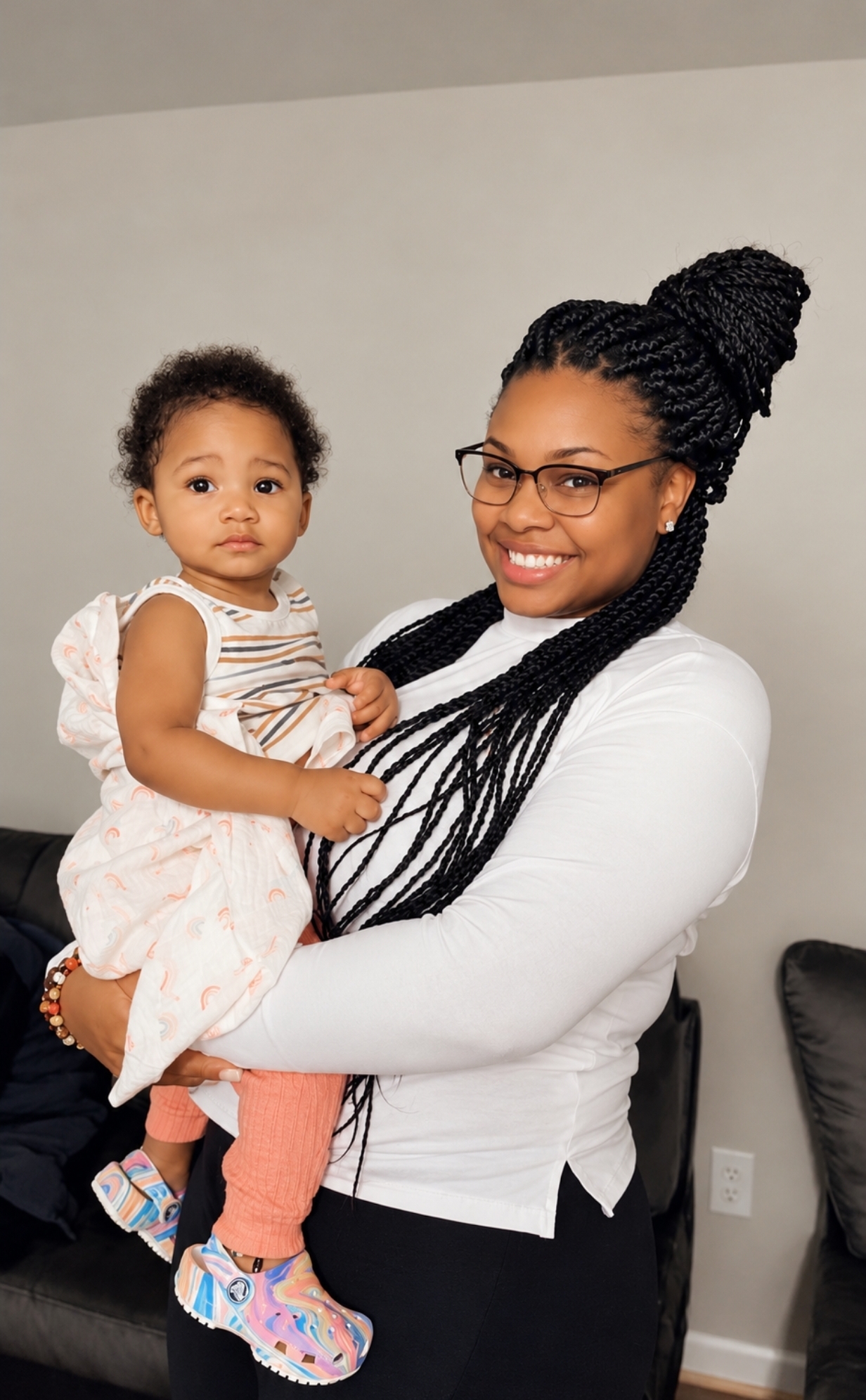 Nanny Kia smiling while holding a toddler