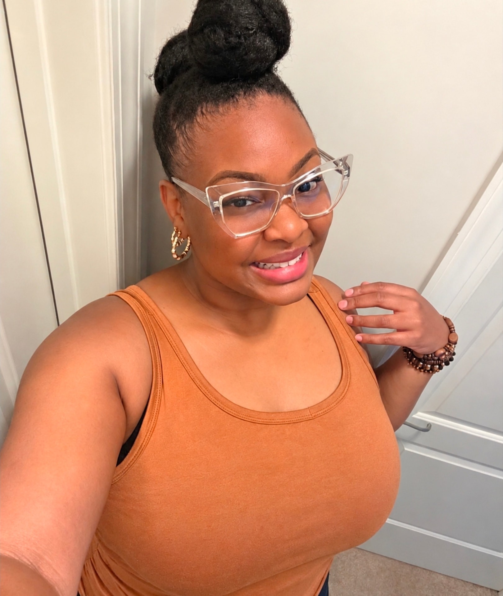 Nanny Kia smiling, wearing glasses
