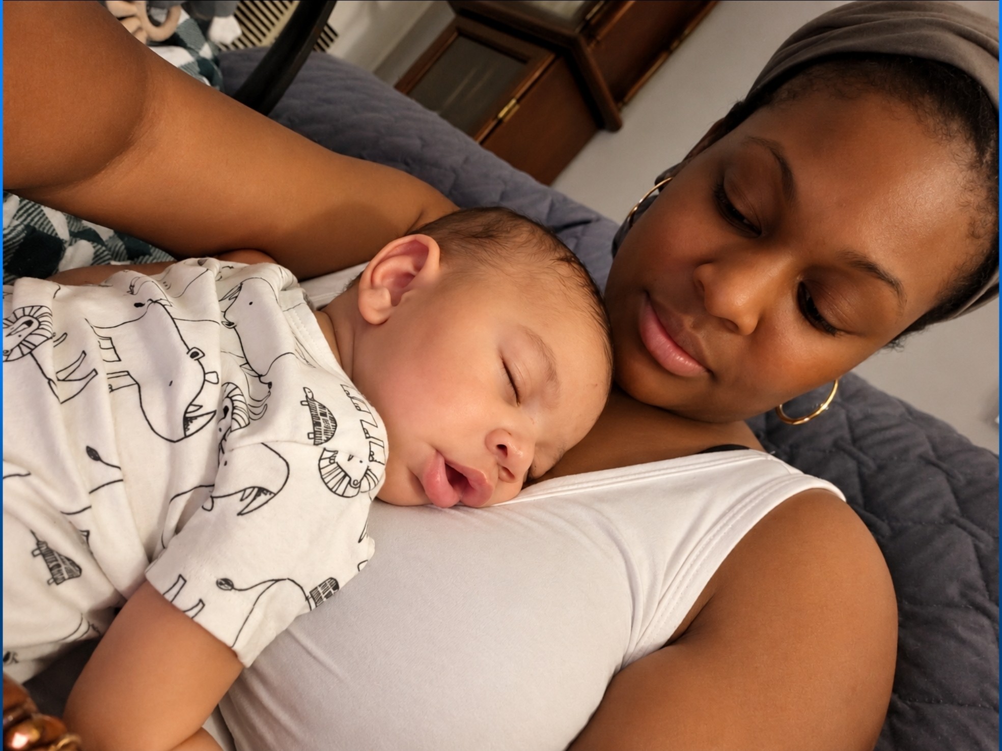 A sleeping newborn resting on Nanny Kia